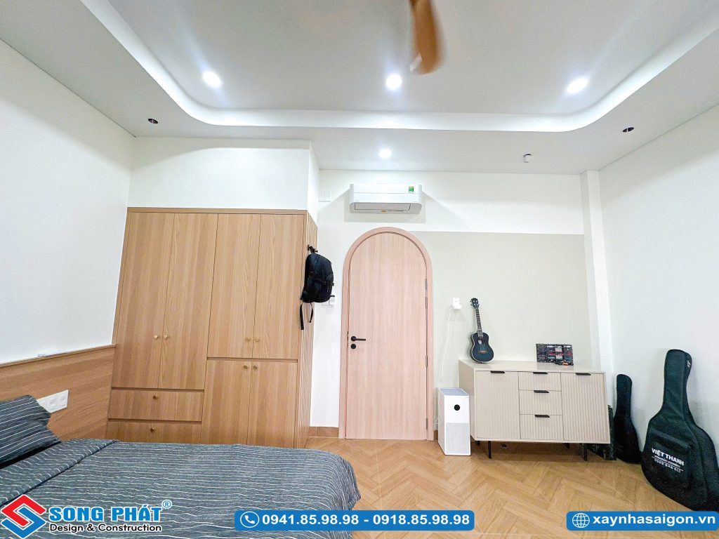 Góc tủ quần áo, cửa ra vào dạng vòm và tủ trang trí nhỏ trong phòng ngủ.