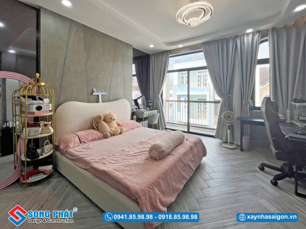 Tone màu xám từ tường đến sàn gỗ tạo sự đồng nhất cho không gian phòng ngủ