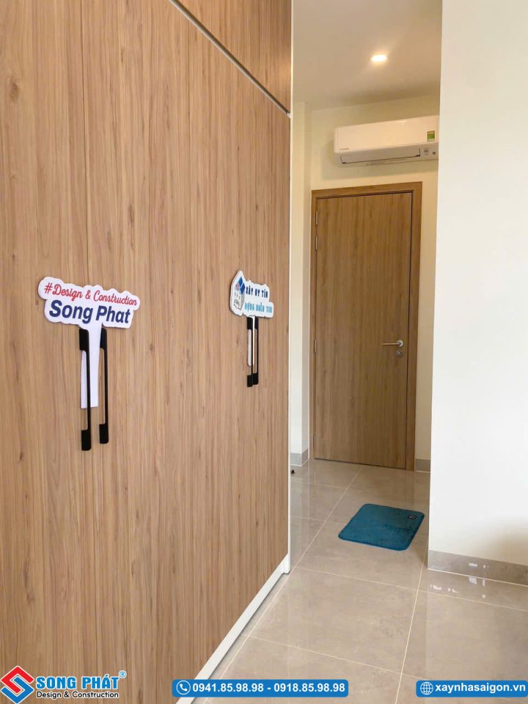 Hệ tủ quần áo vân gỗ ấm áp đặt tại khu vực phòng ngủ.
